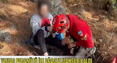 YAMAÇ PARAŞÜTÜ İLE AĞAÇTA MAHSUR KALDI